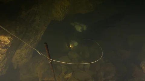 Diver enters the cave extending line to find the way outRisorgenza Amaseno,Italy Stock Footage 108977307