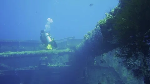 Diver exploring big shipwreck Stock Footage 241086643