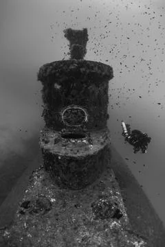 Diver exploring historic shipwreck in clear Maltese waters Stock Photos