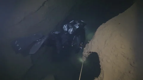 Diver follows guidelines and explores the cracks in the rocks, Amaseno, Italy Stock Footage 224706396