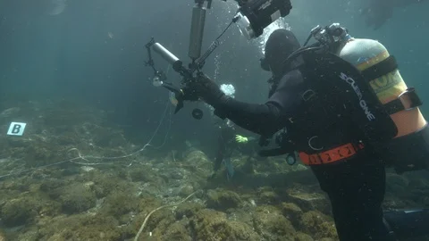 Diver gestures to another diver to come up, Ustica, Sicily, Mediterranean sea Stock Footage 123960955