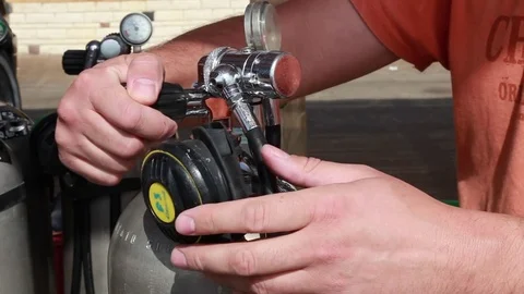A diver getting ready, opens valve on a tank Stock Footage 82731383