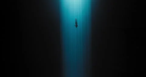 Diver going down with the sun rays Stock Footage 270111258