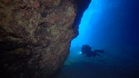 Diver going out from a cave Stock Footage 127941189