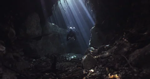 A Diver going through a tight space in the cave Stock Footage 270105724