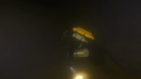 Diver illuminates the backdrop with a torch, Albano lake, Italy Stock Footage 104577999