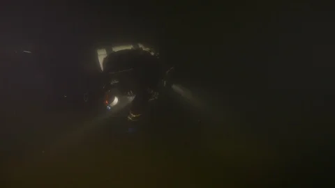 Diver illuminates the bottom of the lake with a torch, Albano lake, Italy Stock Footage 104505159