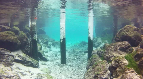 A diver navigates through underwater pilings Stock Footage 62841437