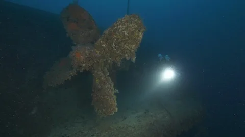Diver passes in front of the propeller of the shipwreck Nasim, Giannutri, Italy Stock Footage 108103196