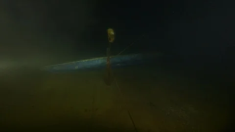 Diver passes next to canoe on the bottom of the lake, Albano lake, Italy Stock Footage 107559487