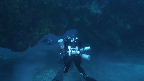Diver passes under a rock arch and finds the other 3, Mediterranean Sea, Italy Stock Footage 115491619