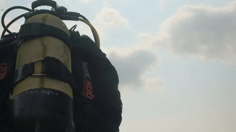 The diver is preparing to dive.Scuba diver wears equipment. close-up of the gear 動画素材 112793526