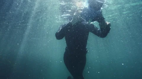 Diver recording a video just underneath the surface Stock Footage 279396149