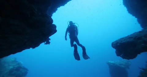 A diver swims inside an underwater cave. Stock Footage 267184412