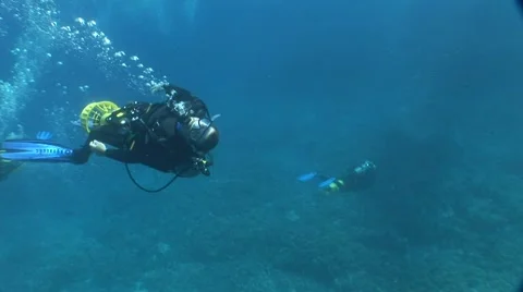 Diver Swims by with a scooter "upside down" Stock Footage 5256858