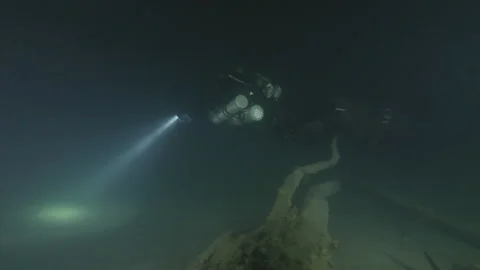 Diver swims on a tree on the sandy bottom of the lake, Albano lake, Italy Stock Footage 224292422
