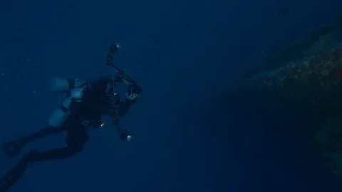 Diver with torch approaches a portion of the shipwreck Rosalie M, Red Sea, Egypt Stock Footage 105615675