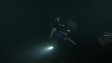 Diver with torch lights up the rocky seabed, Argentario, Mediterranean sea Italy Stock Footage 108781751