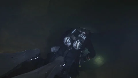 Diver with torch swims on the rocky bottom of the cave,Risorgenza Amaseno,Italy Stock Footage 224489706
