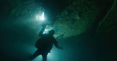 Diver touching the walls of an underwater cave, Gramat, France Video stock 104242279
