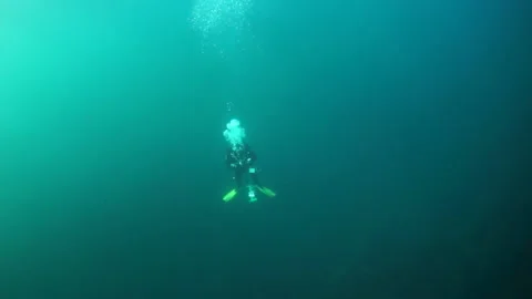 Diver under the surface of the water against the sun. 스톡 동영상 155156387