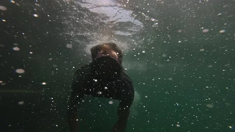 Diver waves his hands at the camera underwater Stock Footage 197405963