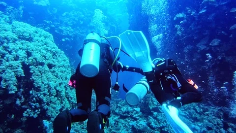 A diver without air led by the dive instructor. Stock Footage 123622762