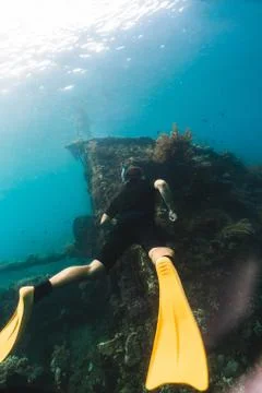 Diver without scuba explores the wrecked ship Stock Photos