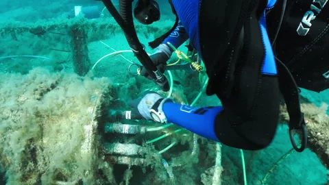 Diver working on a wired underwater station Stock Footage 263116280