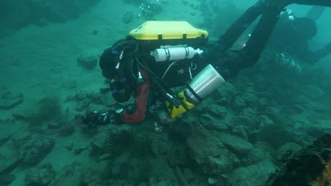 Divers arrive to underwater road made to build the dam ,S.Domenico lake,Italy Stock Footage 108675517