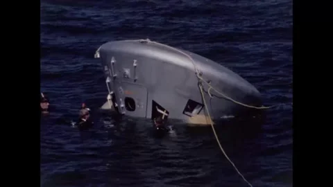 Divers assisting Apollo 8 back-up crew command module water egress training Video stock 271518592