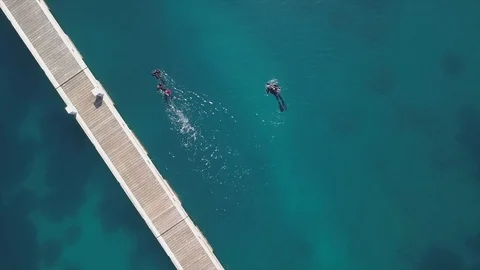 Divers Beside Jetty in Aqua Blue Water in Croatia, 4k Stock Footage