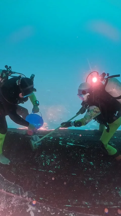 Divers Clean Boat Upside-Down, Motobu, Japan - 28 Dec 2023 Stock Footage 323404477