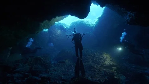 Divers come out of the crack under the rocks, Ustica, Mediterranean sea Stock Footage 126892610