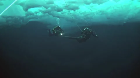 Divers explore the underwater world of the Arctic Ocean at the North Pole. Stock Footage 63027628