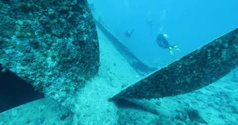 Divers explore the wreck of the SS Thistlegorm. Top diving wreck dives Stock Footage 292881568