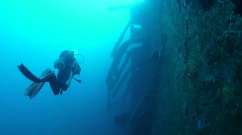 Divers exploring the side of the USS Coolidge Wreck Stock Footage 40731721
