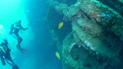 Divers exploring the side of the USS Coolidge Wreck Stock Footage 40731723