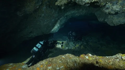 Divers go down the crevices between the rocks, Ustica, Mediterranean sea Stock Footage 126894656