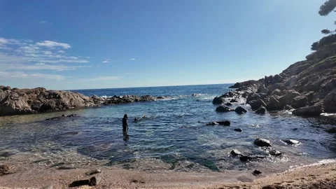 Divers on the idyllic mediterranean beach with calm water, 4K Stock Footage 271128711