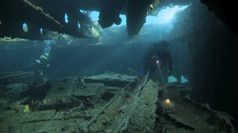Divers inside the ship wreck Stock Footage 22694881