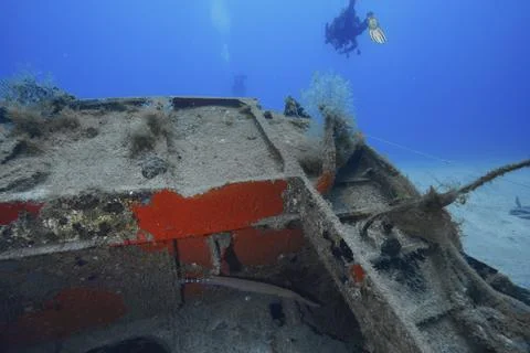 Divers inspecting a rusty part of a sunken ship, meteor wreck dive site, Russian Stock Photos