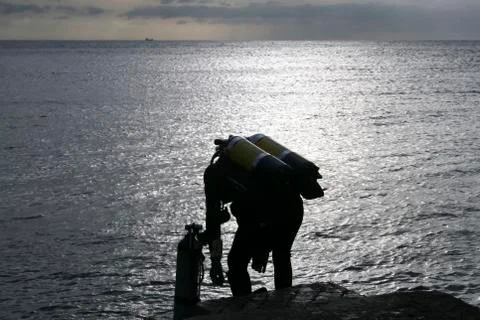 Divers preparing to jump into the sea Stock Photos