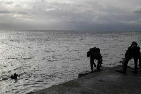 Divers preparing to jump into the sea Stock Photos