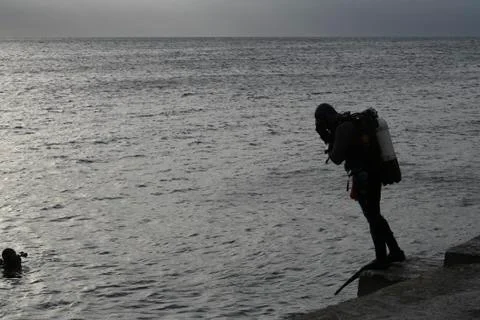 Divers preparing to jump into the sea Stock Photos