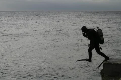 Divers preparing to jump into the sea Stock Photos