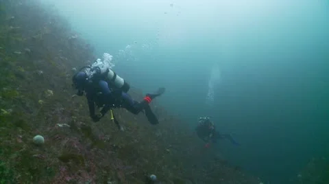 Divers rock wall Stock Footage 12450693