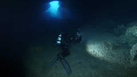 Divers on sandy bottom in the cave, Ustica, Mediterranean sea Stock-Footage 126909905