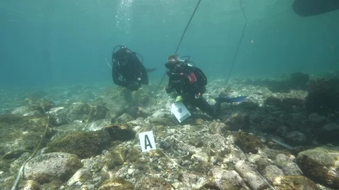 Divers set up a simulation of an underwater crime near their boat,Ustica Med sea Stock Footage 123984750