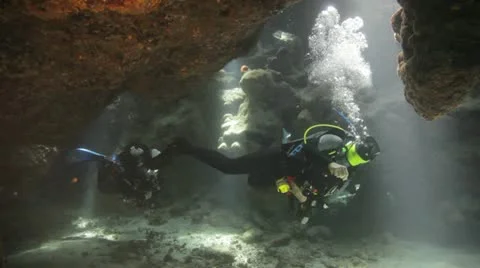 Divers swimming inside the cave Stock Footage 22643210